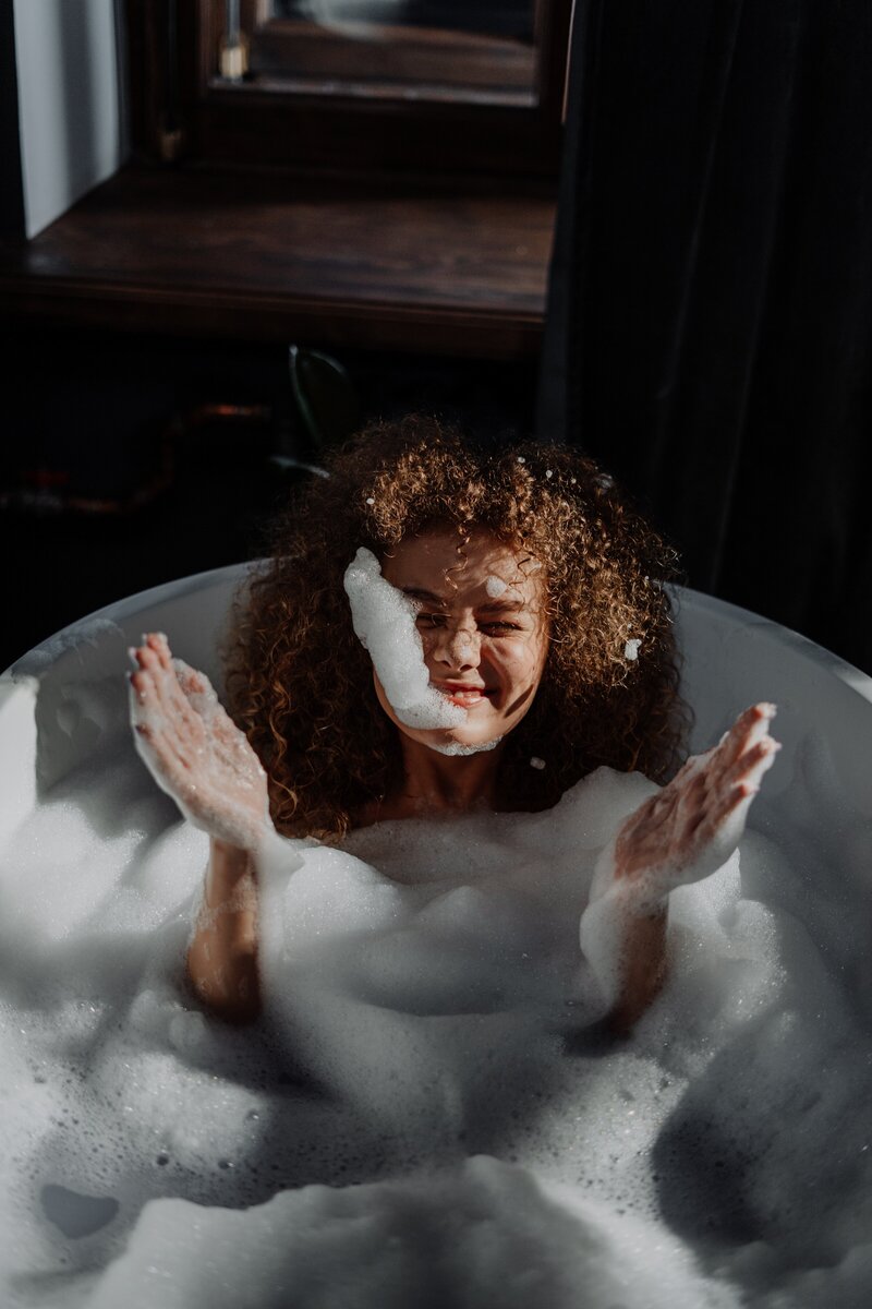 Woman smiling in bubble bath