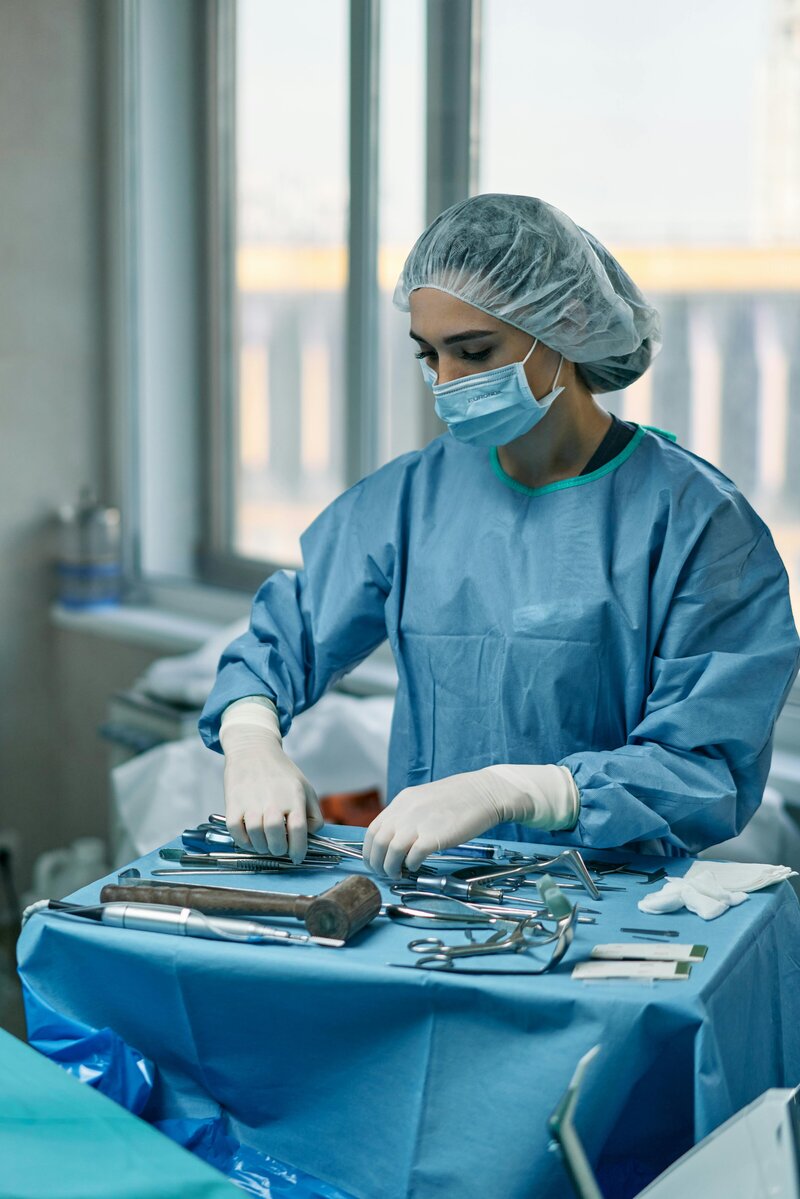 female nurse arranging surgical tools