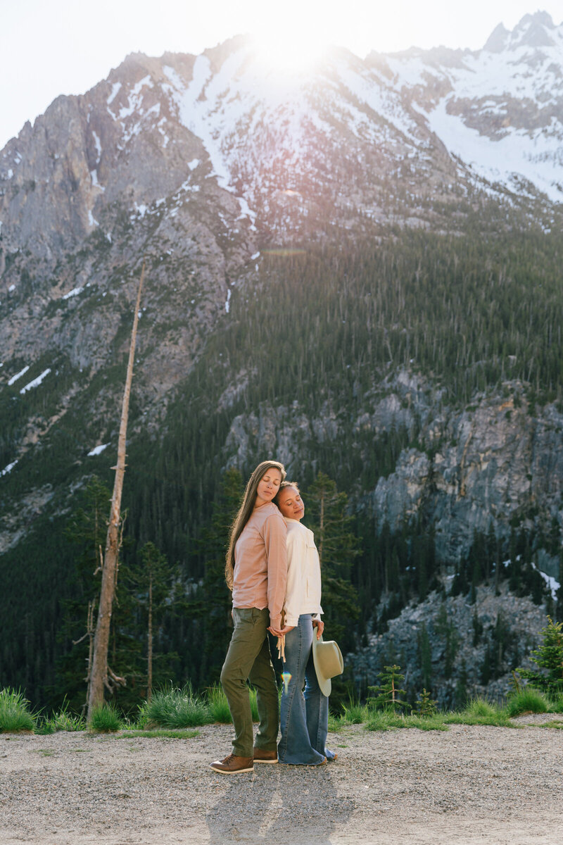 Two brides wearing casual clothes for their sunrise photo session at Washington Pass in the North Cascades National Park near WInthrop, WA.