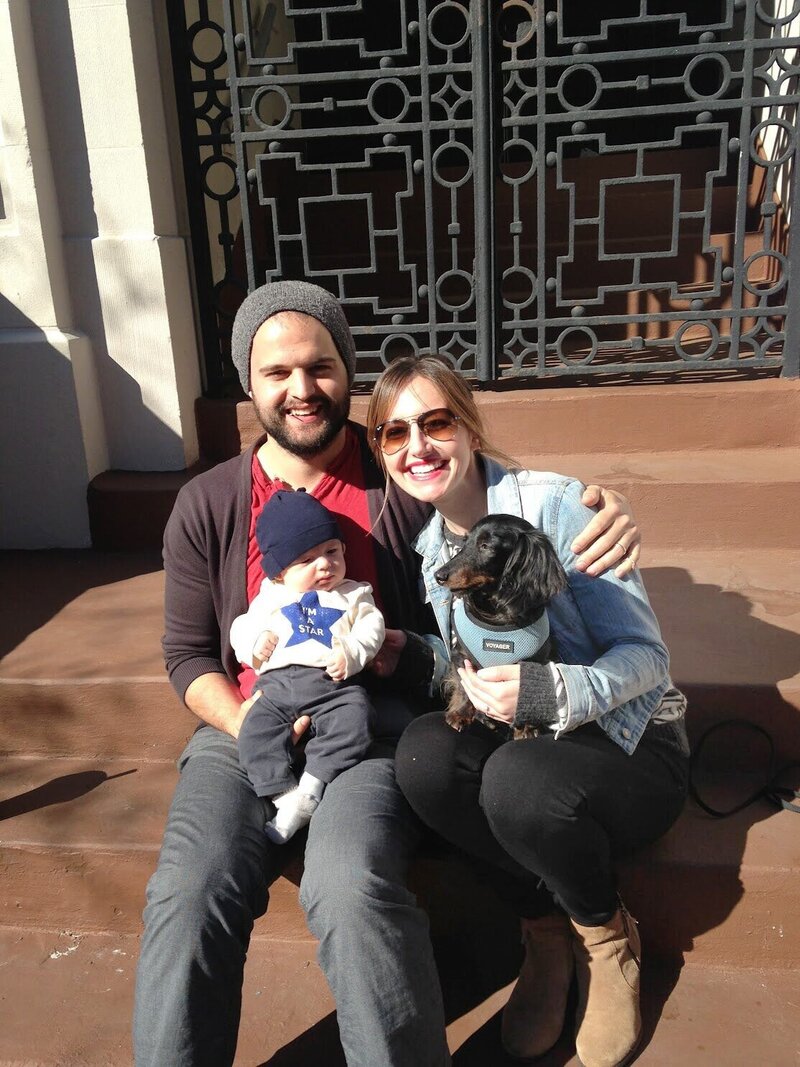 Ali, her husband, son, and dog sitting on stairs