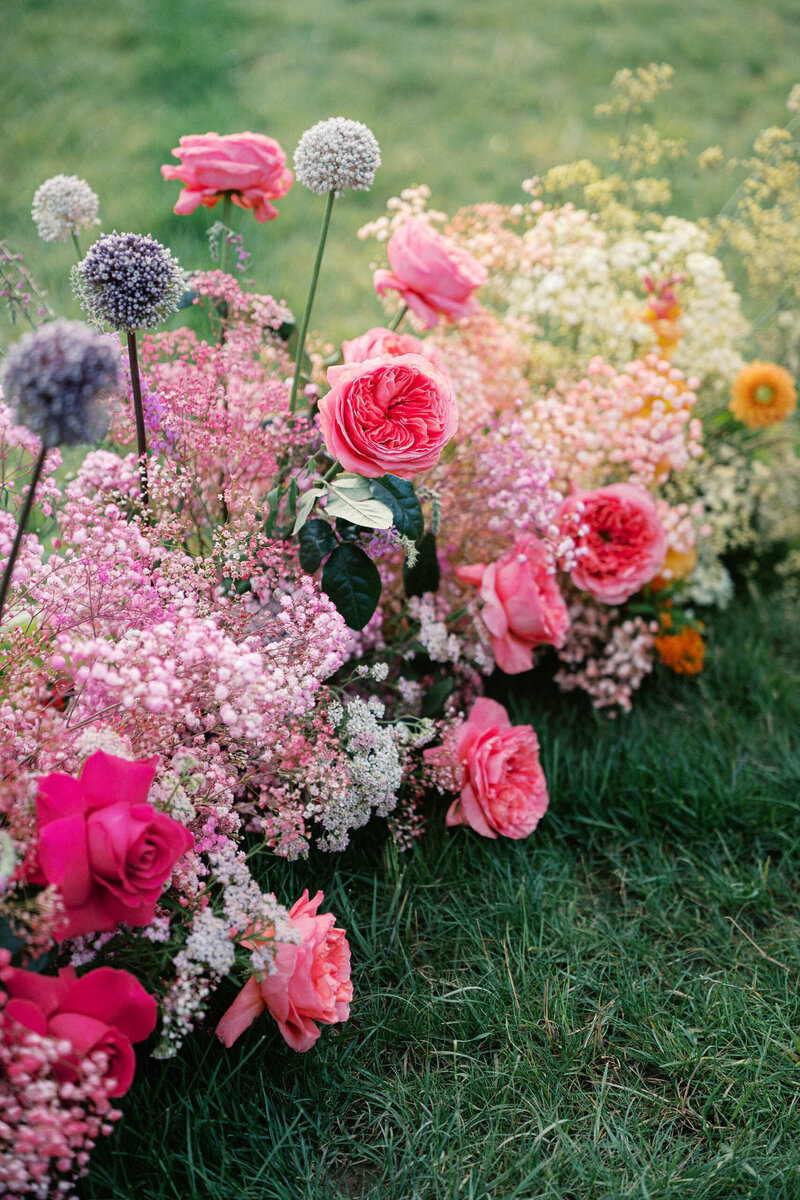 colorful and bold and lush pink purple and yellow ceremony florals taken by boston documentary wedding photographer