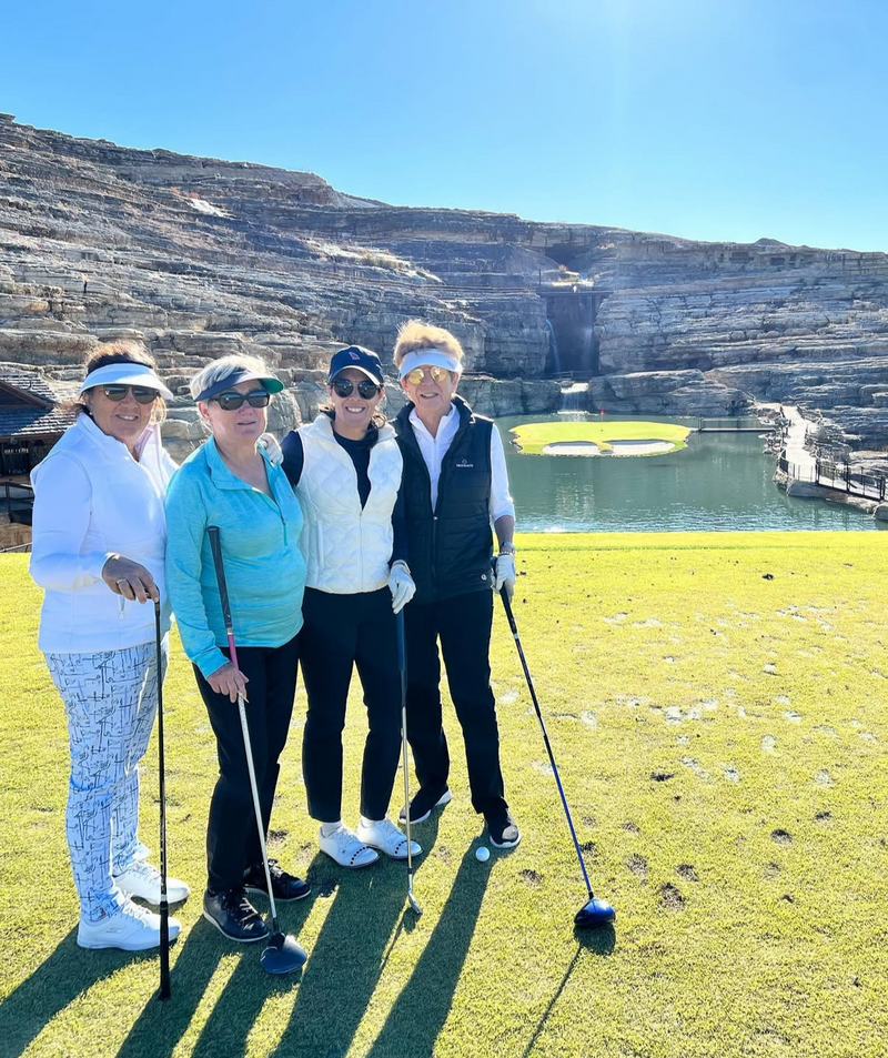 Renee O’Higgins, PGA and LPGA golf instructor playing golf with members during golf retreat in Montana.