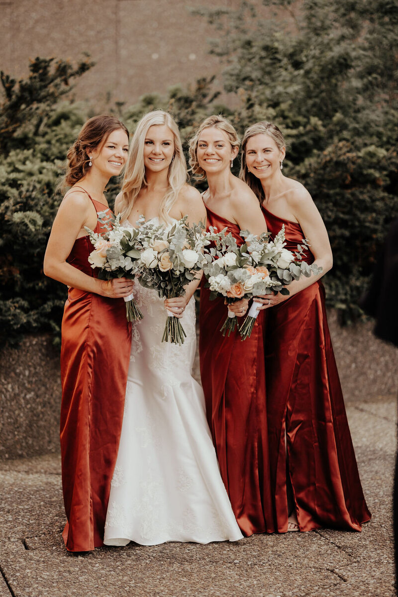 Bridesmaids in rust bridesmaid dresses