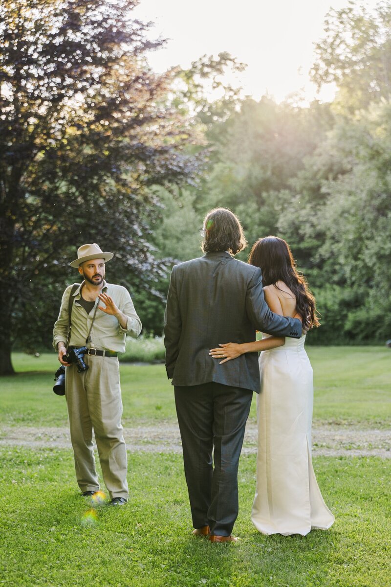 Kenneth, Hudson Valley wedding photographer, directing a couple during golden hour portraits