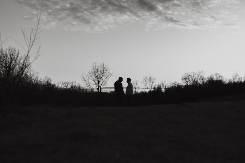 couple from far away in front of setting sun