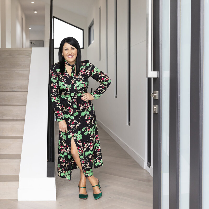 Interior designer standing in front doorway of a home