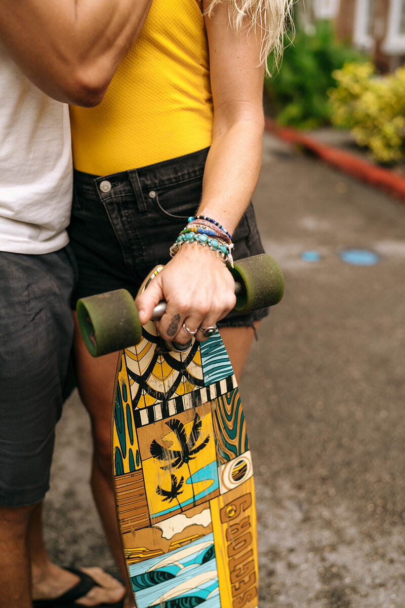 couple hands on skateboard
