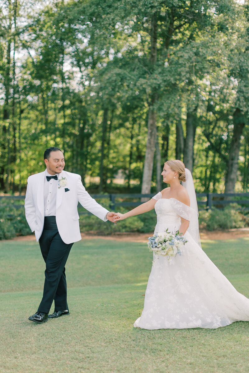 This romantic wedding couple in Athens, GA features stunning bridal hair and makeup by Kayla Walters Beauty Collective. Our team creates timeless looks that make your special moments unforgettable. Schedule your wedding now!