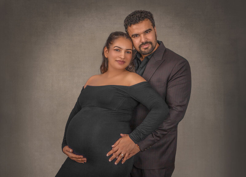 "A romantic maternity session featuring a couple, captured in an intimate and loving moment, showcasing the joy of expecting a baby in Ottawa."