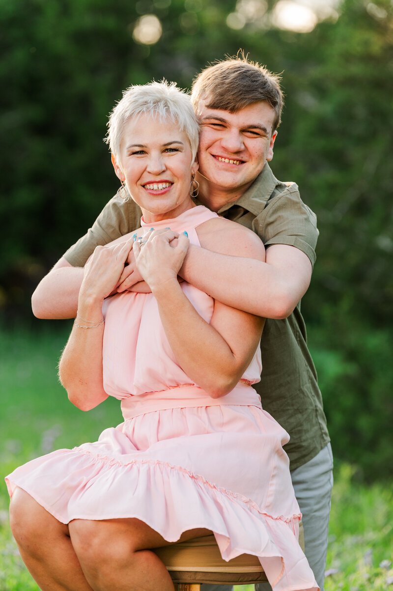 Backlit Spring Portrait with a  Mother and Son embracing. Photo taken by Lydia Teague Photography.