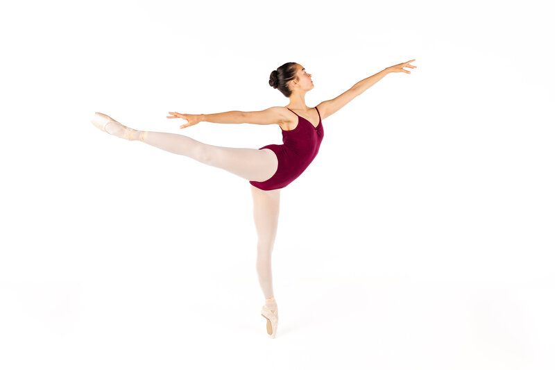 Dancer gracefully cupping a cluster of flowers