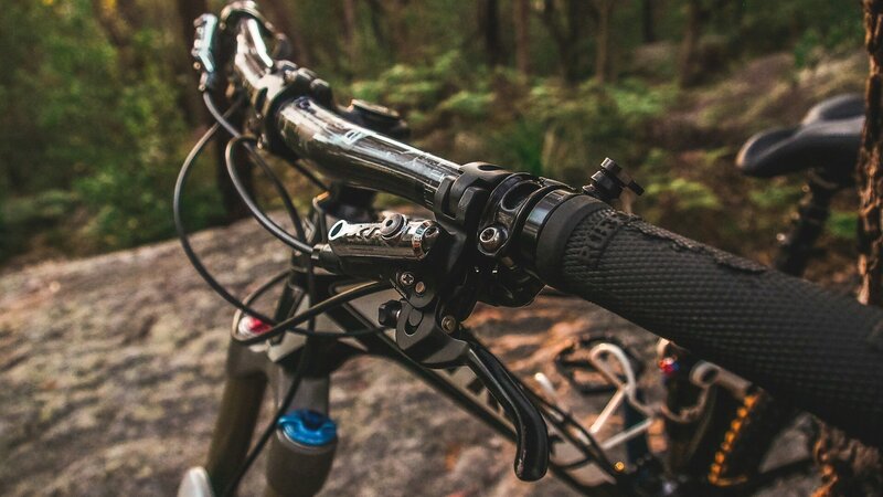 The top of a mountain bike, showing the handle bars and gear/brake levers.