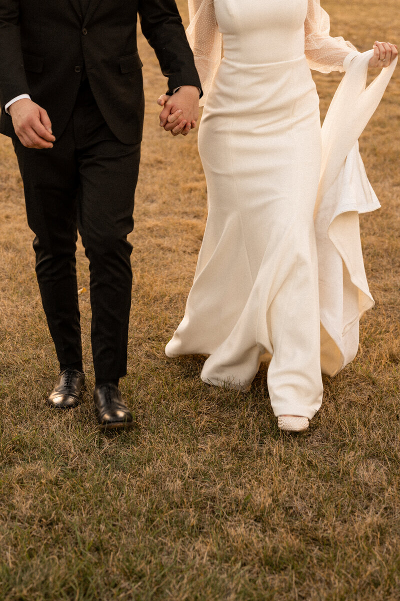 Bride and groom holding hands taken by Idaho elopement photographer.