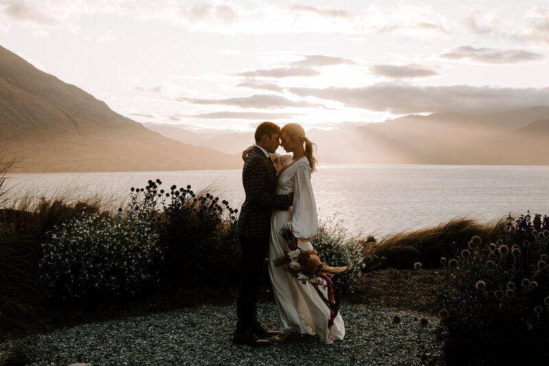 The Lovers Elopement Co - bride and groom enbrace at sunset at Jack's Retreat Queenstown wedding venue