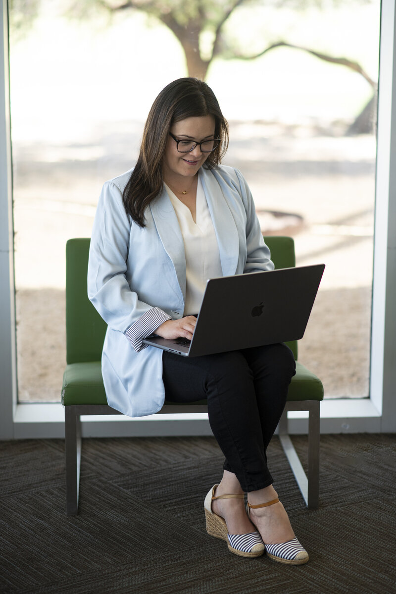 Luisa Kidwell in a blue blazer sitting and working on a laptop – Career and Communication Coach at Kidwell Coaching and Consulting 8