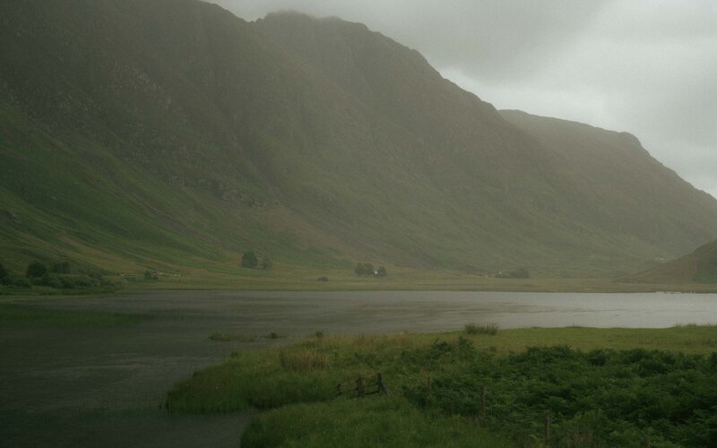 A breathtaking view of Loch Achtriochtan in Glen Coe, capturing the tranquil lake surrounded by majestic mountains and natural beauty