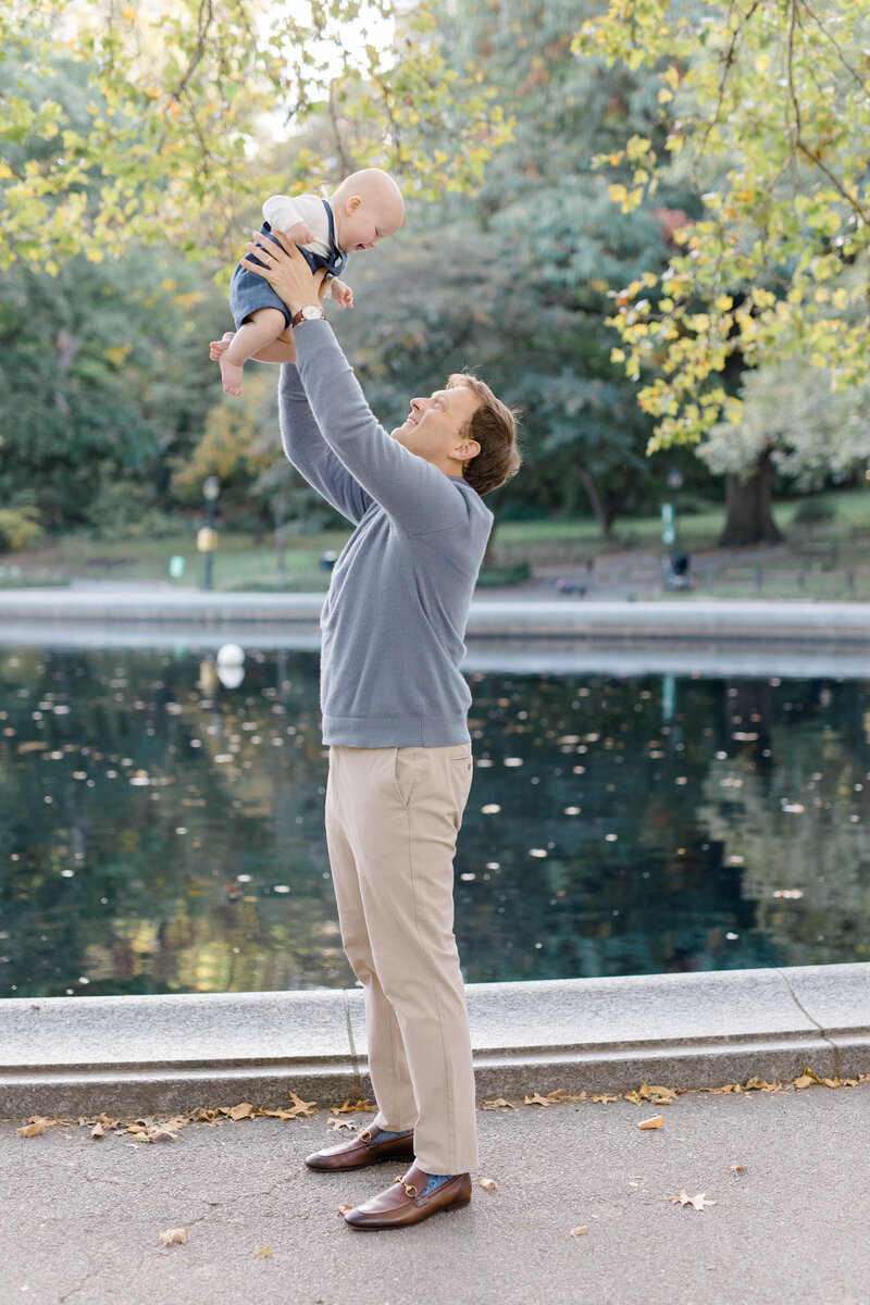 Dad throwing baby in air by Brooklyn family photographer
