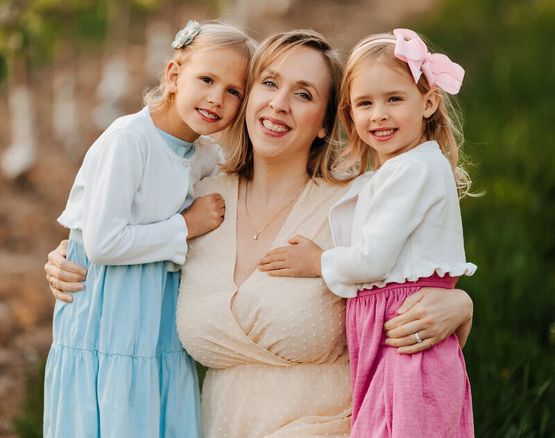 photographer and her daughters pose for a photo together