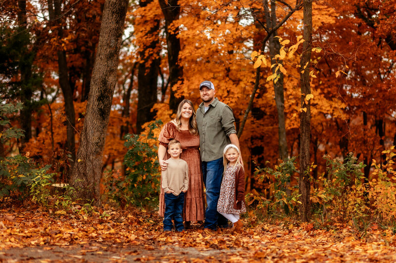 Vibrant fall family portrait amidst the colorful foliage at Bothwell Lodge State Historic Site near Sedalia, Missouri, captured by Brittany Jewell Photography.