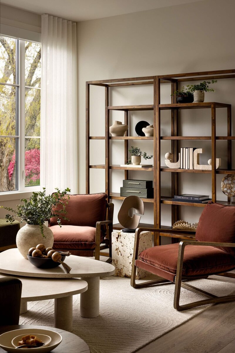 Serene Japandi-style library featuring rich rust hues, natural wood shelves, and a cozy, grounded aesthetic for quiet reading moments.
