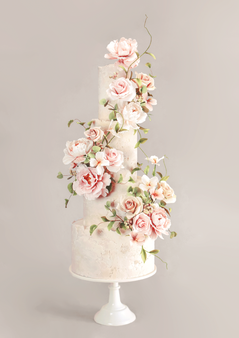 four tiered romantic wedding cake with stone effect fondant and whimsical sugar flowers