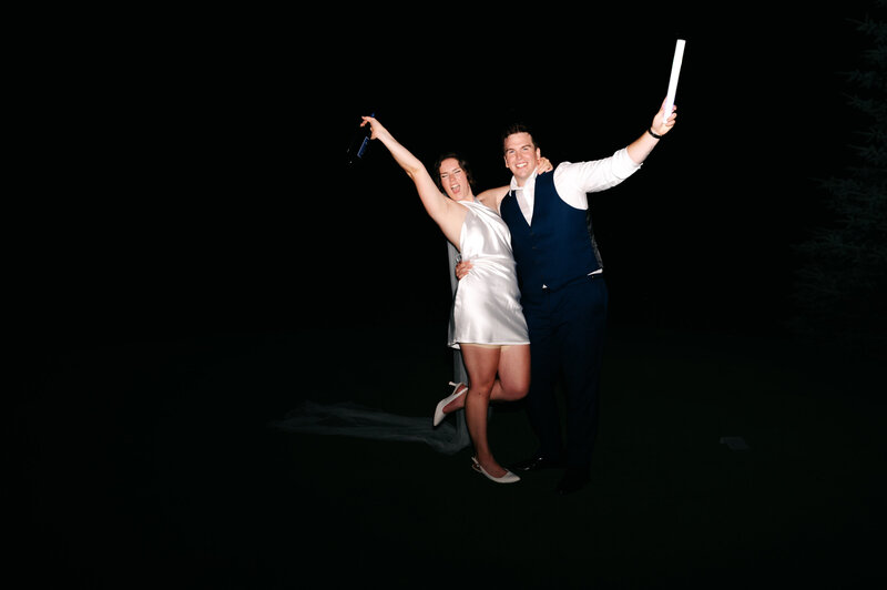 two brides smiling holding hands at Ontario wedding
