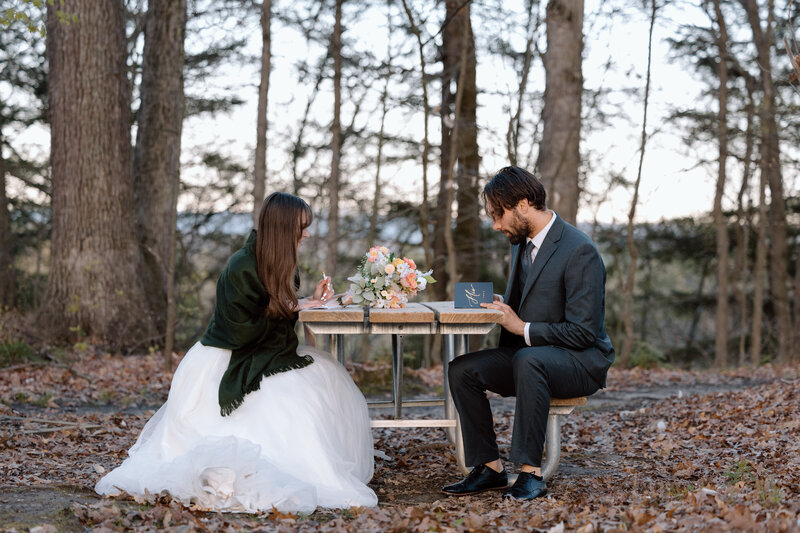 Bride and groom writing vows during their hiking elopement.