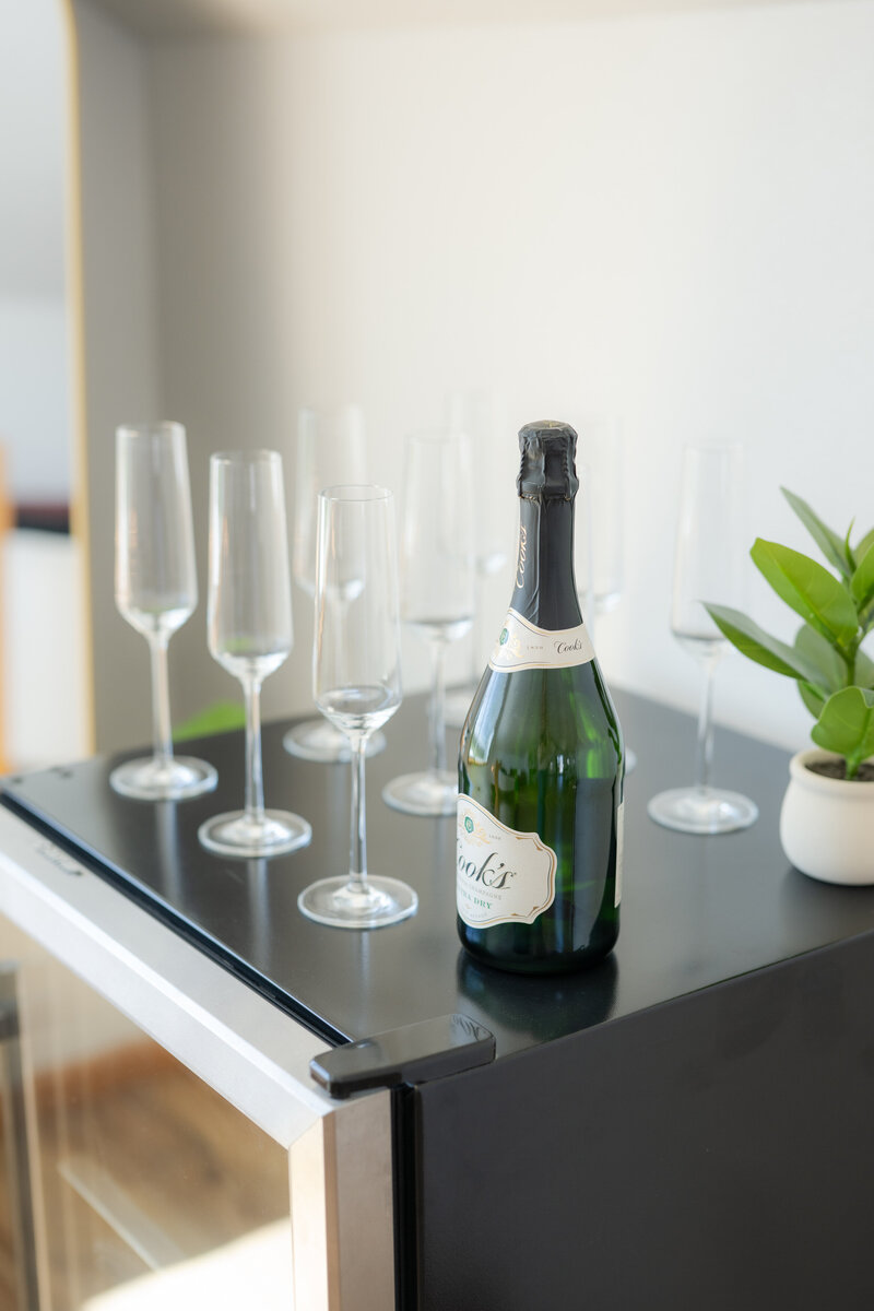 Champagne and mini fridge in the bridal loft at The Era Wedding & Event Venue 