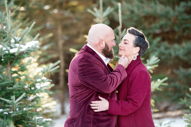 Emotional outdoor portrait of Kari and her husband Todd sharing a tender moment in coordinating burgundy coats, reflecting the enduring love story behind Kari Dawson + Co and her deep belief in legacy-driven wedding photography
