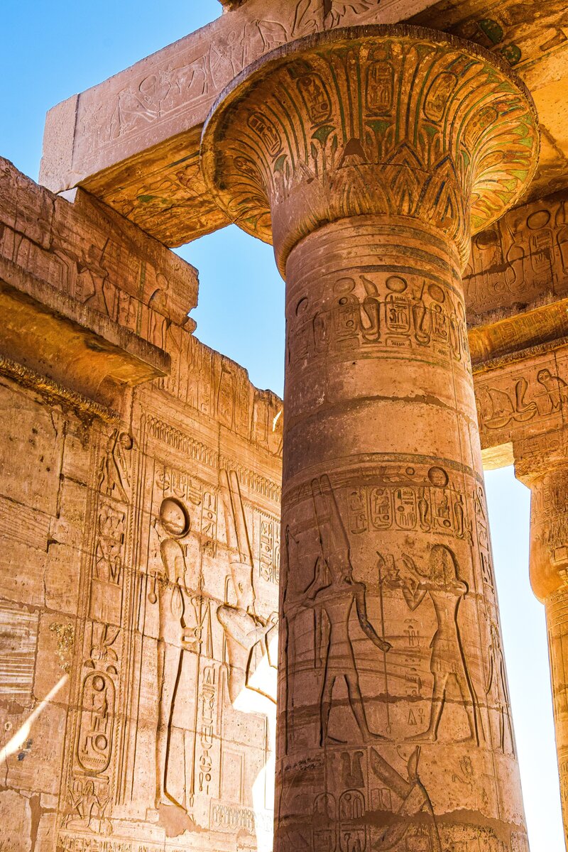 Columns filled with hieroglyphs inside the Hypostyle Hall of Karnak Temple in Luxor Egypt.