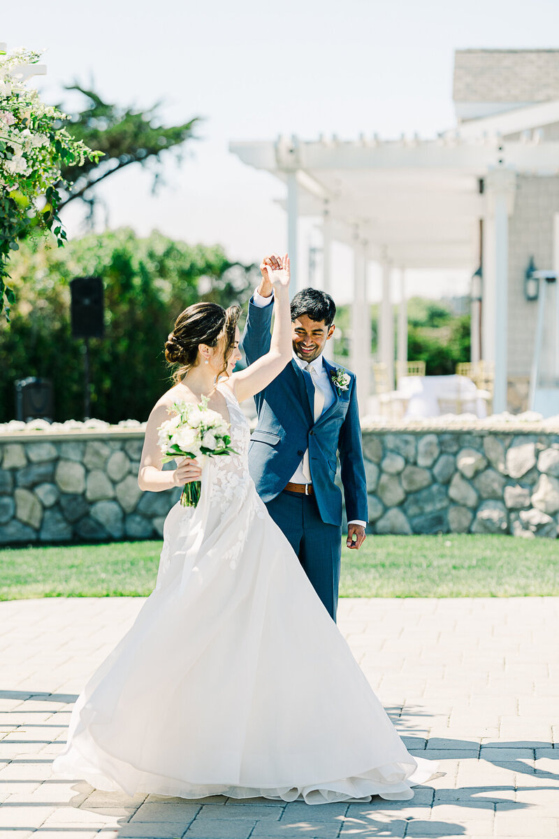 Romantic coastal wedding ceremony in Half Moon Bay, California, featuring a bride and groom with stunning ocean views, sandy beaches, dramatic cliffs, and picturesque sunset skies.