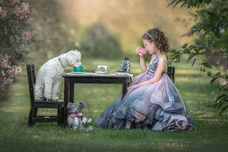 : "Children playing with their dog in a lush outdoor setting, captured in a lively and fun-filled family portrait session in Ottawa."