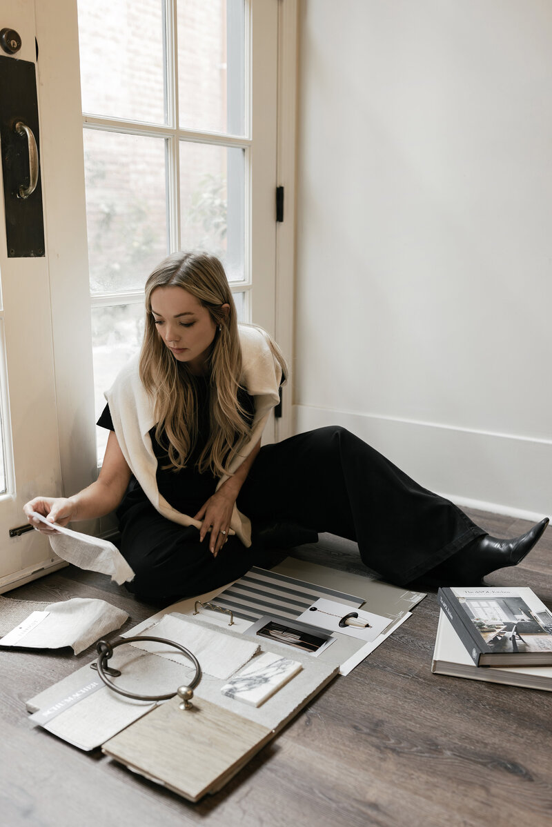 Candid branding photo of an interior designer building a mood board on the floor — photographed in Greenville SC by Dani Lacey Photographs.