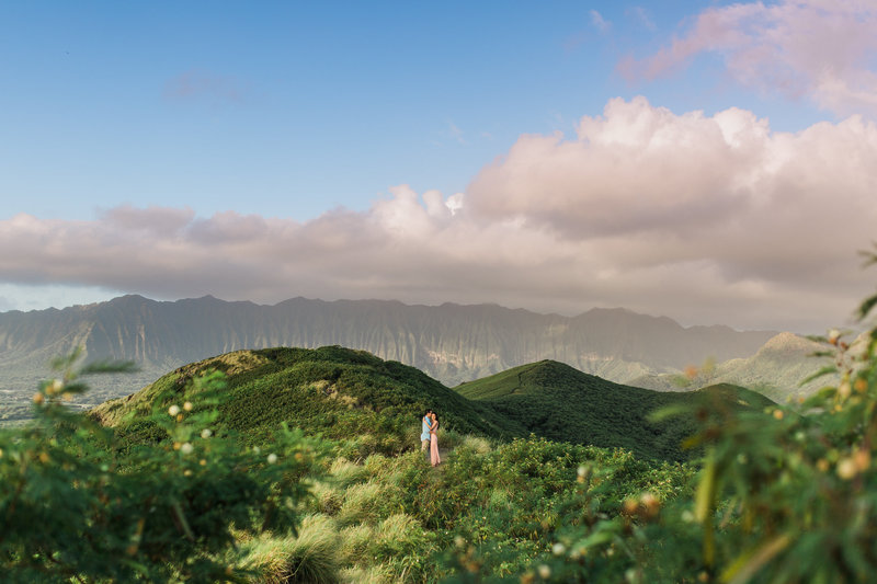 couple embracing in front of mountains engagements