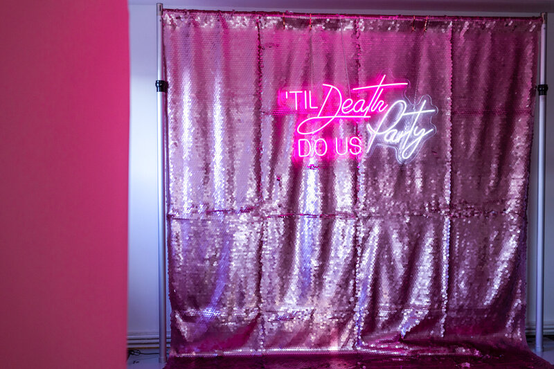 lilac sequins photo booth backdrop for hire for Valentine's day or corporate events with "Tile death Do us Party Neon Sign"