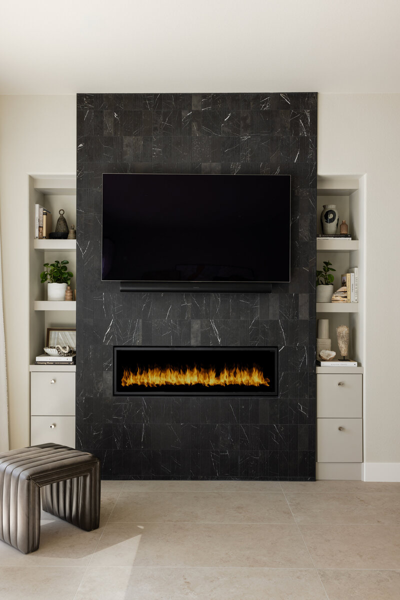San Clemente remodel.  Black marble fireplace with built-in cabinetry and floating shelves.