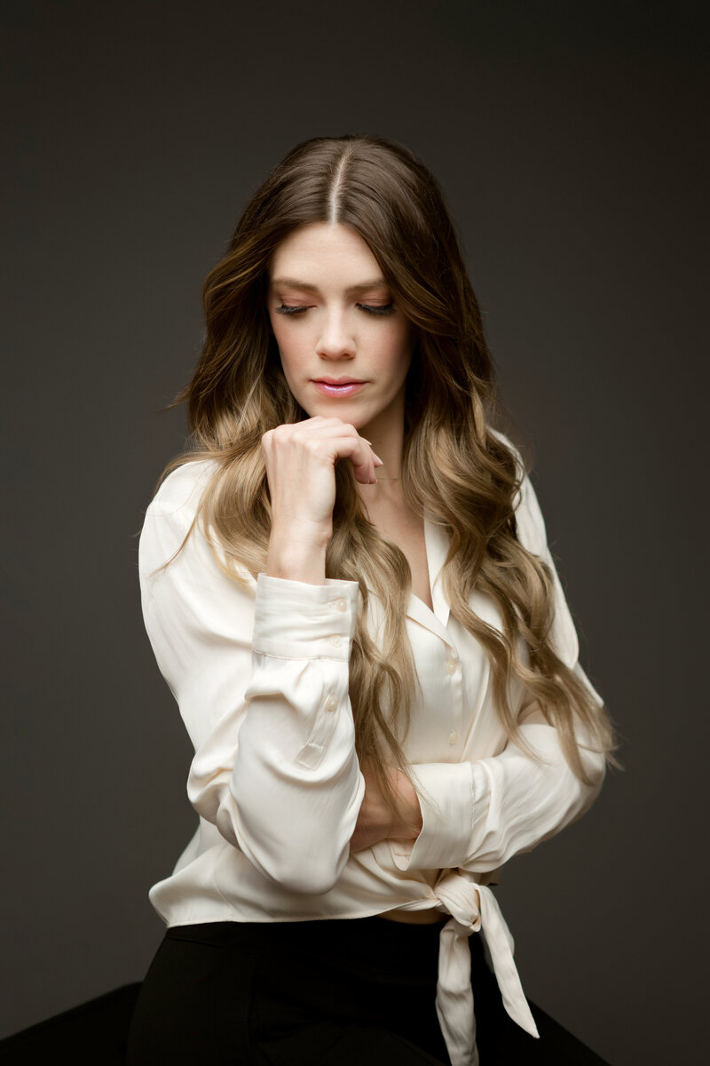 Woman looks downwards while taking portrait