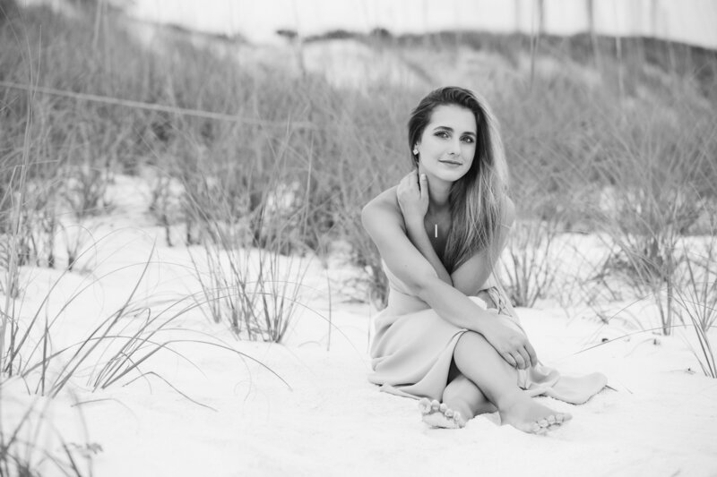 A young woman sitting in the sand