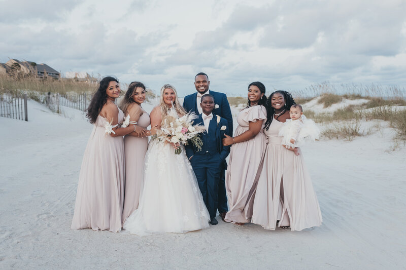 bride and groom with bridesmaids on the beach at omni resort hilton head