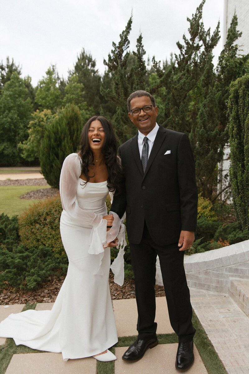 Father daughter first look laughing