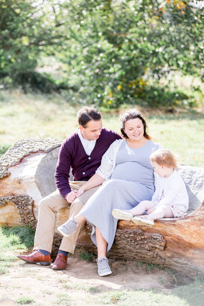 Family sat on a log at their London Family Mini Shoot with Philippa Sian Photography