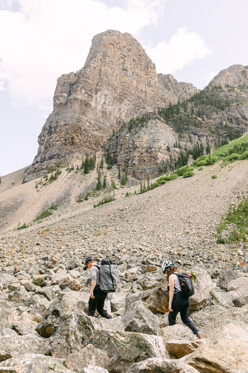 Capture the adventurous spirit of a bride and groom who changed into hiking gear to venture up to the top of a mountain for their elopement. A unique and breathtaking moment of love and exploration.