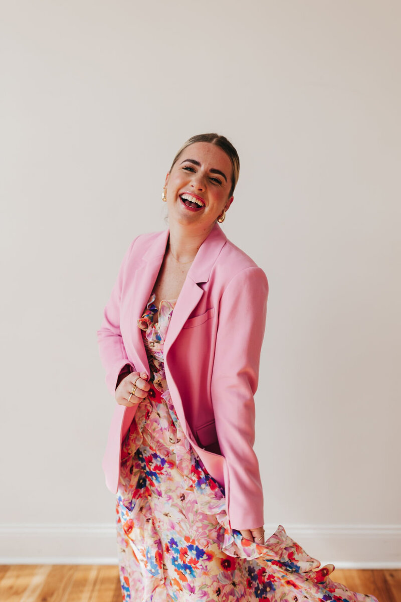SJB Photos Sarah Jane Bradley laughing in pink blazer and floral dress