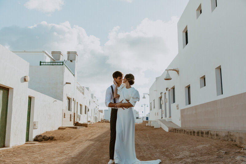 Man holding woman from behind and embracing