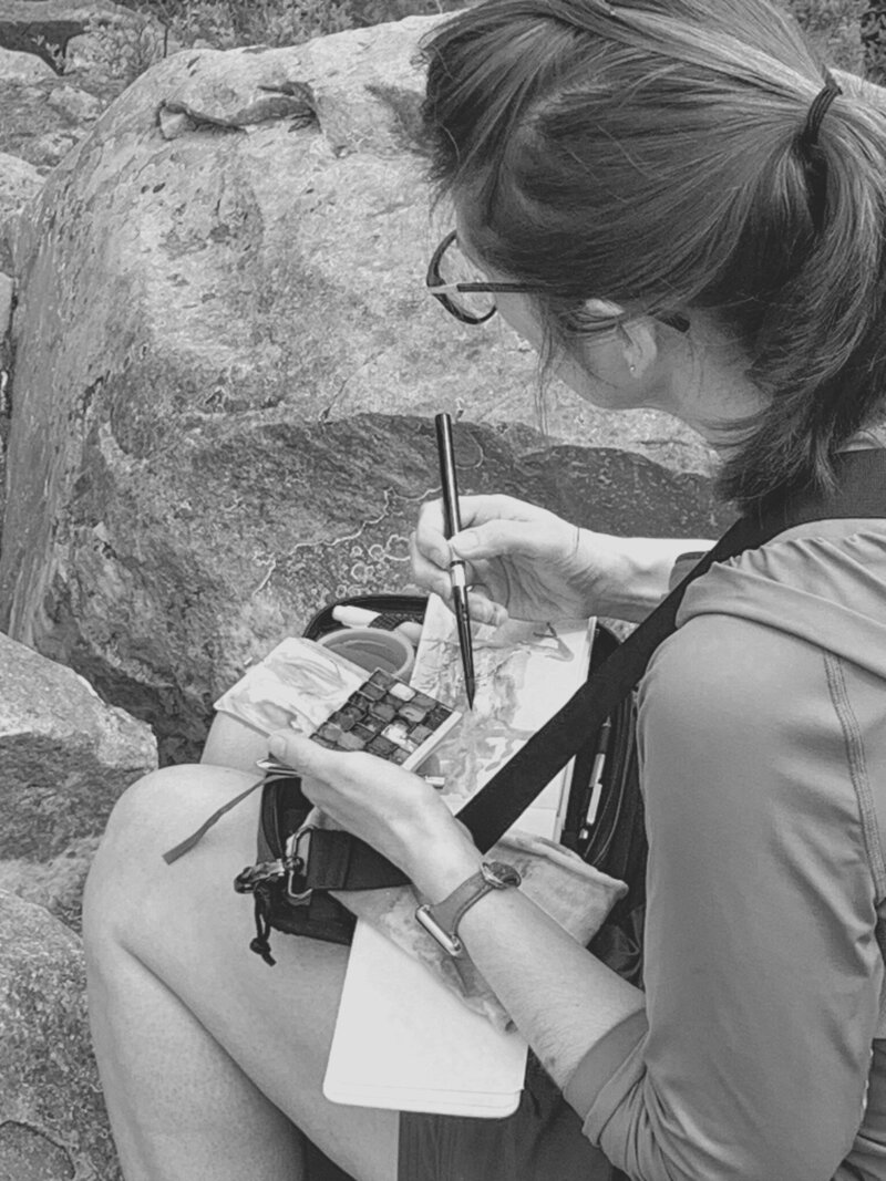 Jill Gustavis with a stack of Sketchbooks