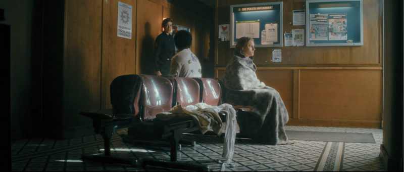 A rooftop scene at sunset with panoramic city views and quiet intimacy.