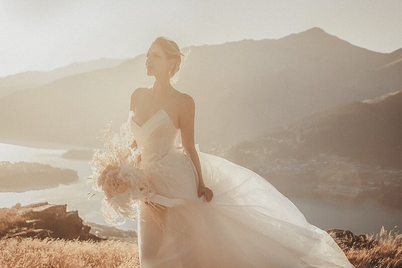 A golden light outdoor photoshoot of a woman wearing a couture dress.