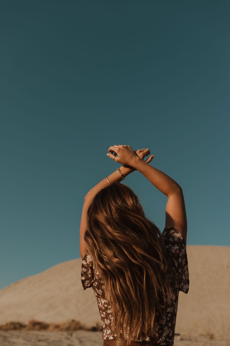 Woman with her arms raised above her head