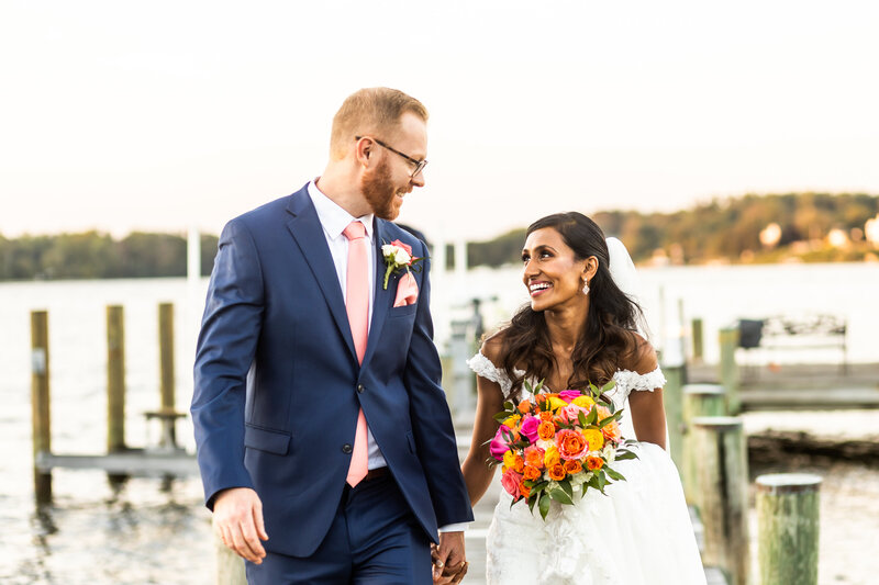 Bride and Groom hand in hand on the pier, Annapolis Wedding Photographer