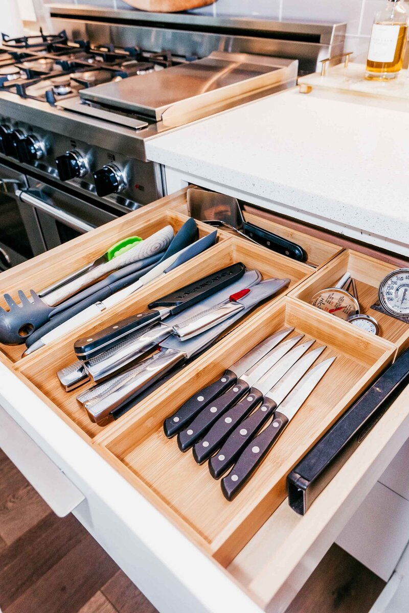 A kitchen drawe featuring organized knives and utensils